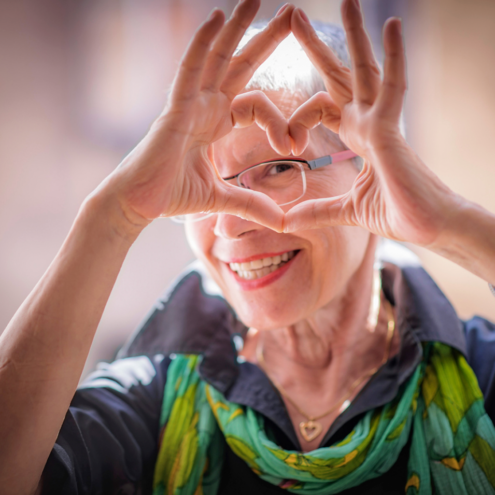 A woman showing a heart with her hands